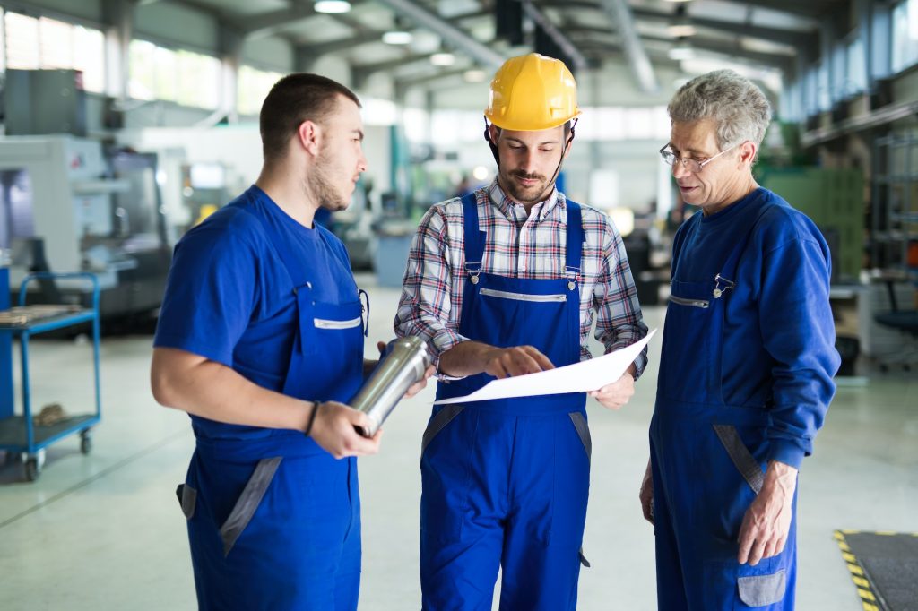 Team Of Engineers Having Discussion In Factory